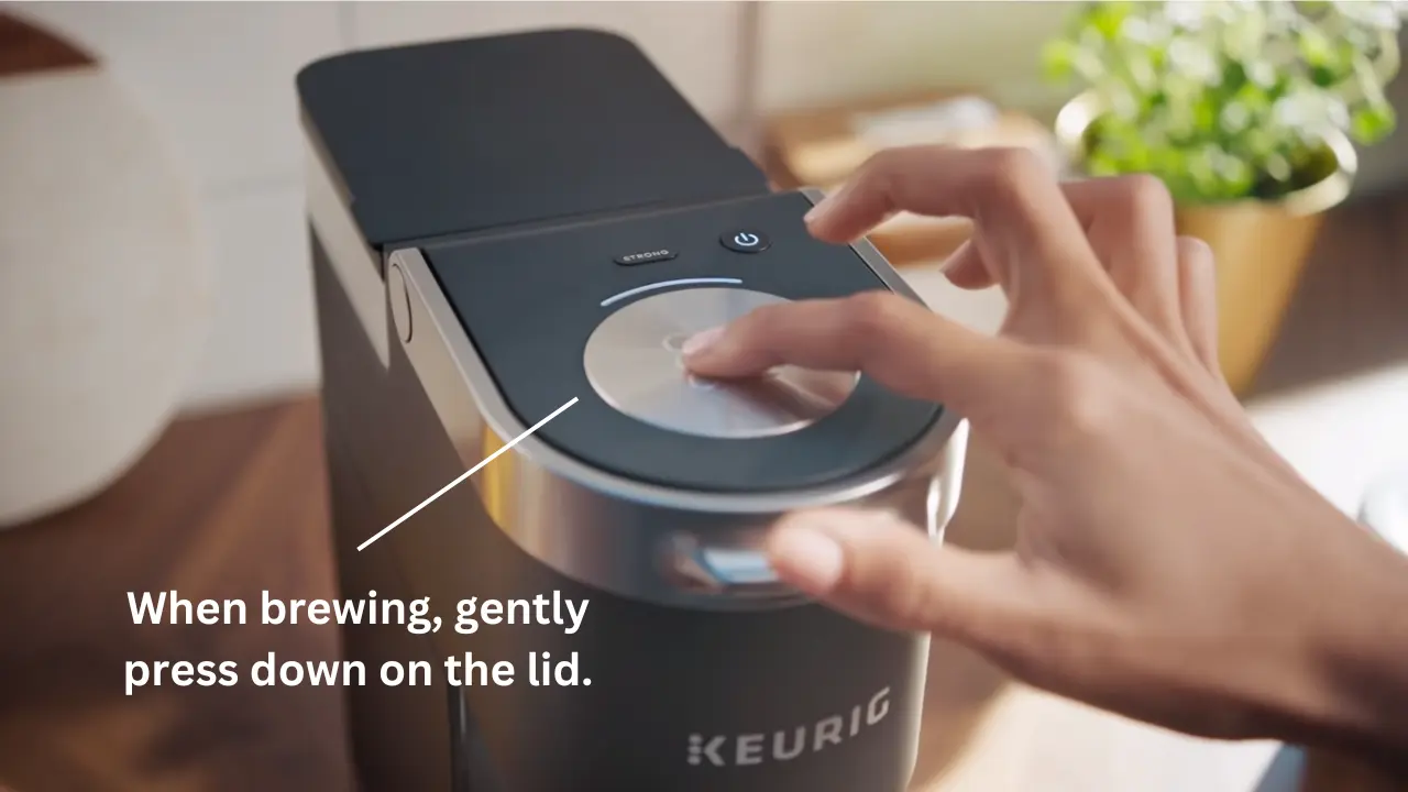 When brewing, gently press down on the lid - Keurig Mini