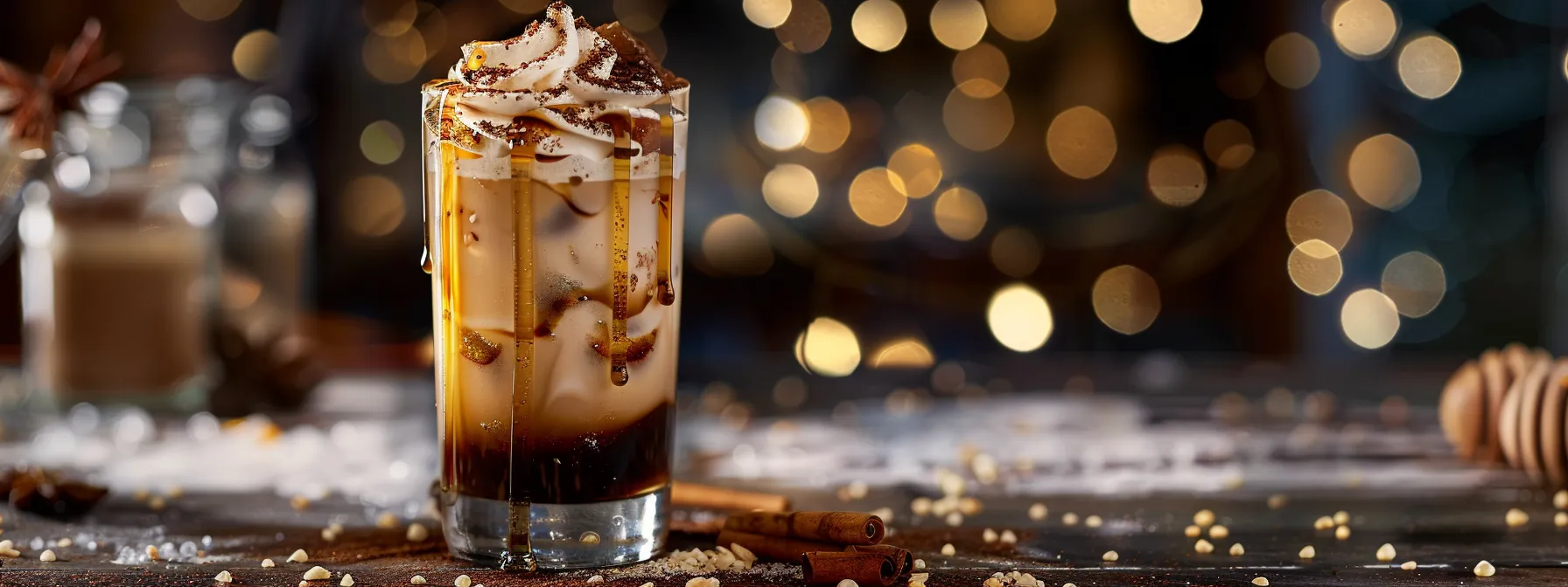 a glass of customized brown sugar iced coffee adorned with almond milk swirls, sprinkled with spices and extracts, and topped with honey drizzle and artistic ice cubes.